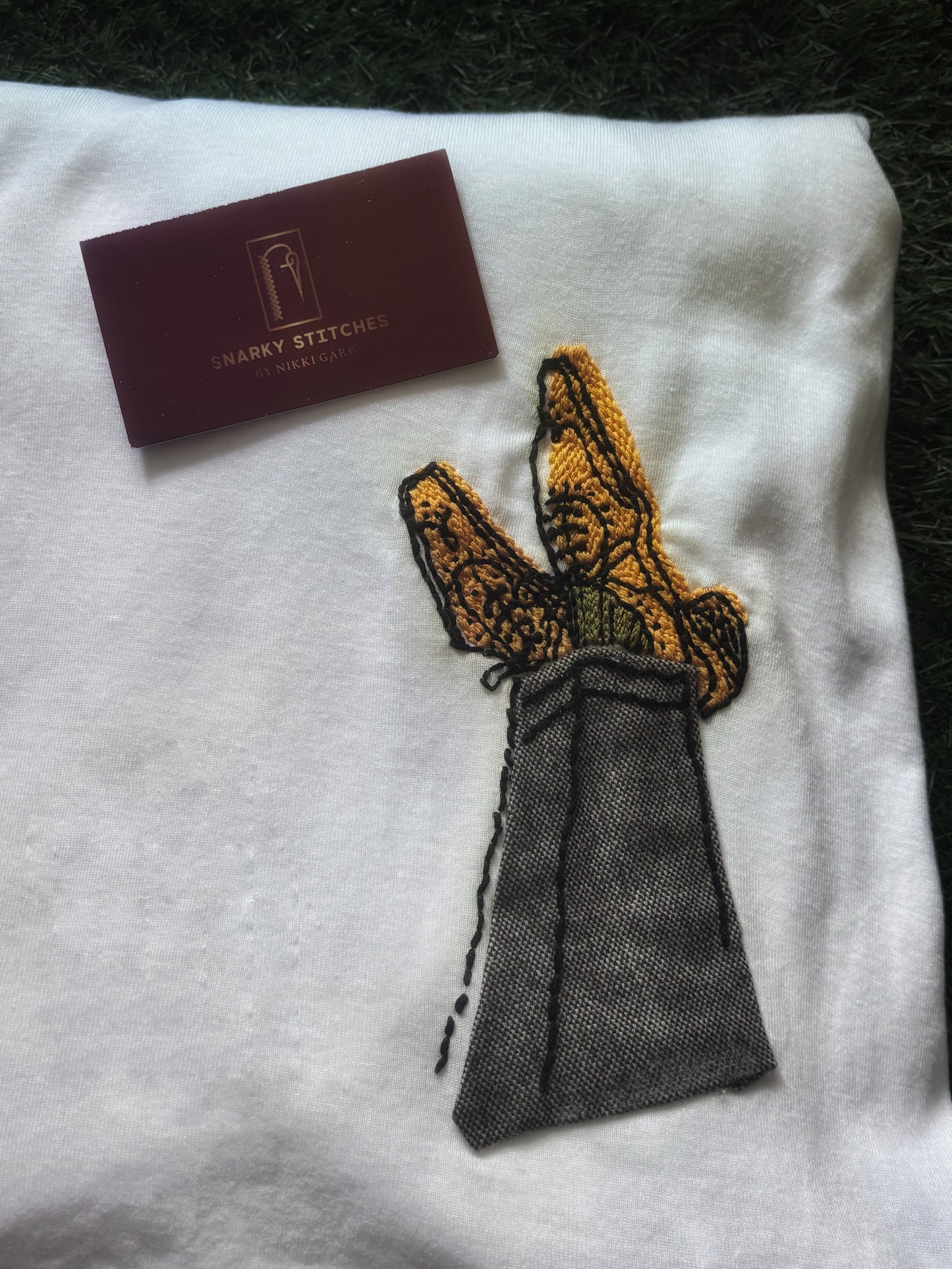 Crossed Tweed Legs with Hand Embroidered Shoes and Socks on White Tshirt